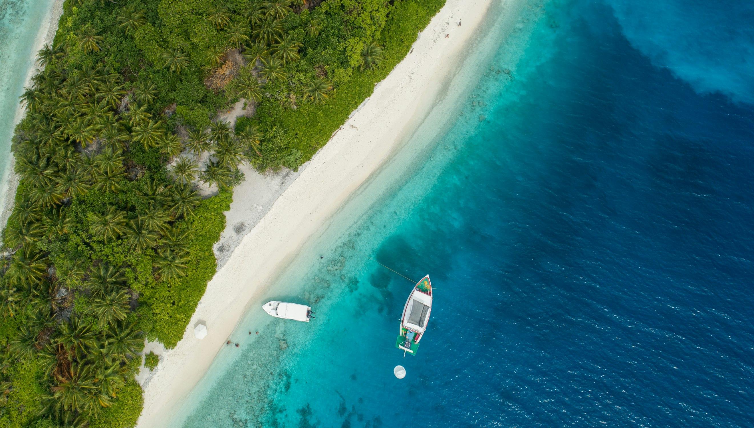 Aerial view of a sailboat on the open ocean.